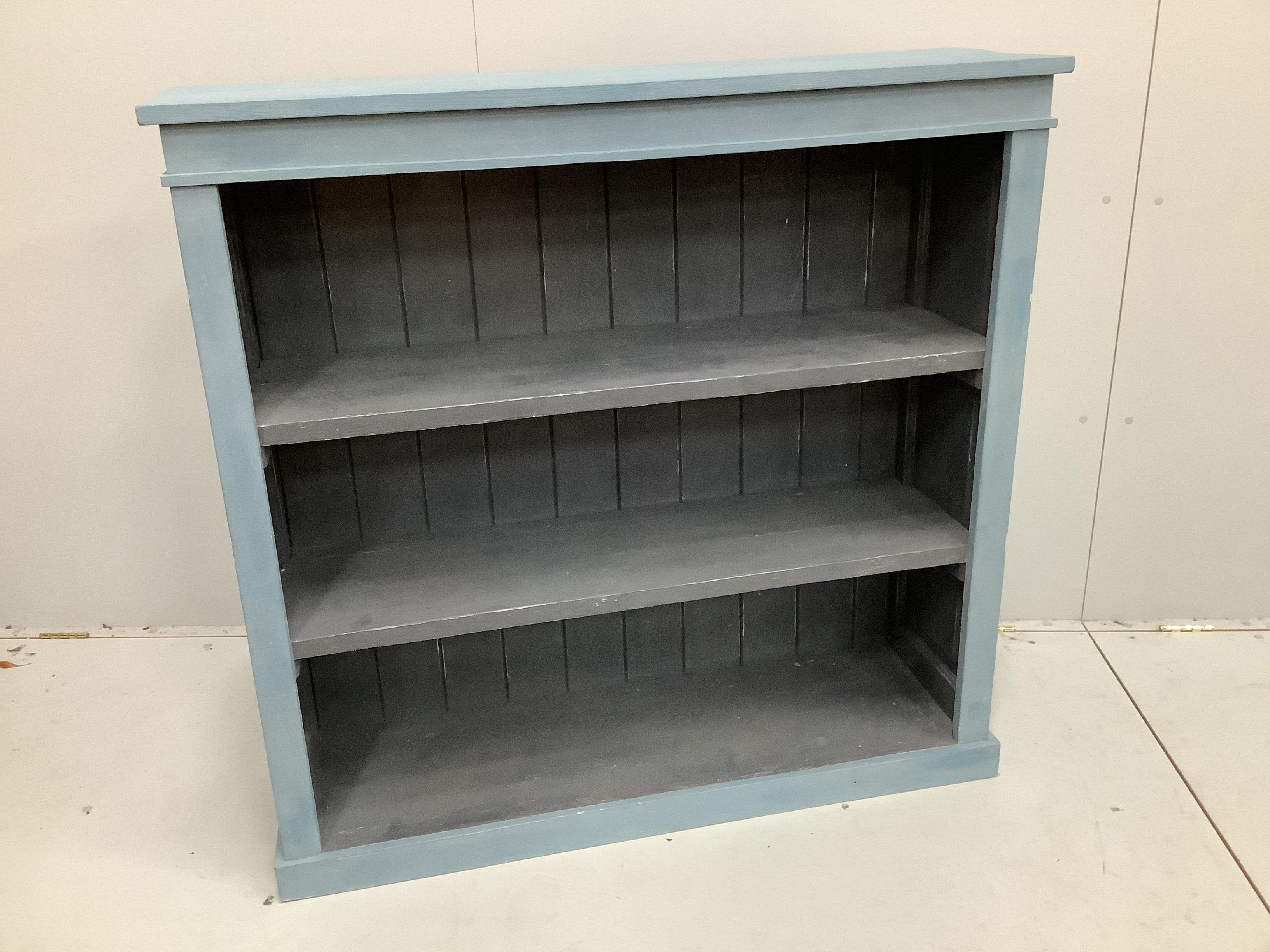A Victorian style painted open bookcase, width 120cm, depth 38cm, height 117cm